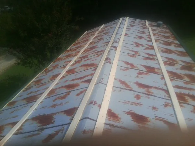 Rusted metal roof panels with new wood purlins before replacement — Storm Damage Roof Repair in Eastham by Roofing Brothers